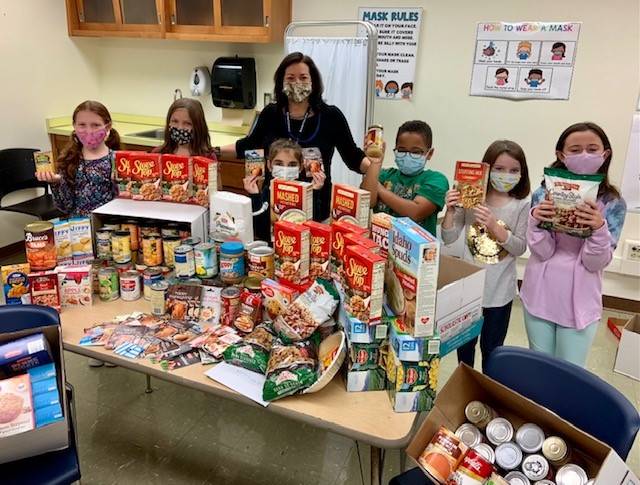 Burchfield students help Mrs. Vita collect food for Thanksgiving dinners