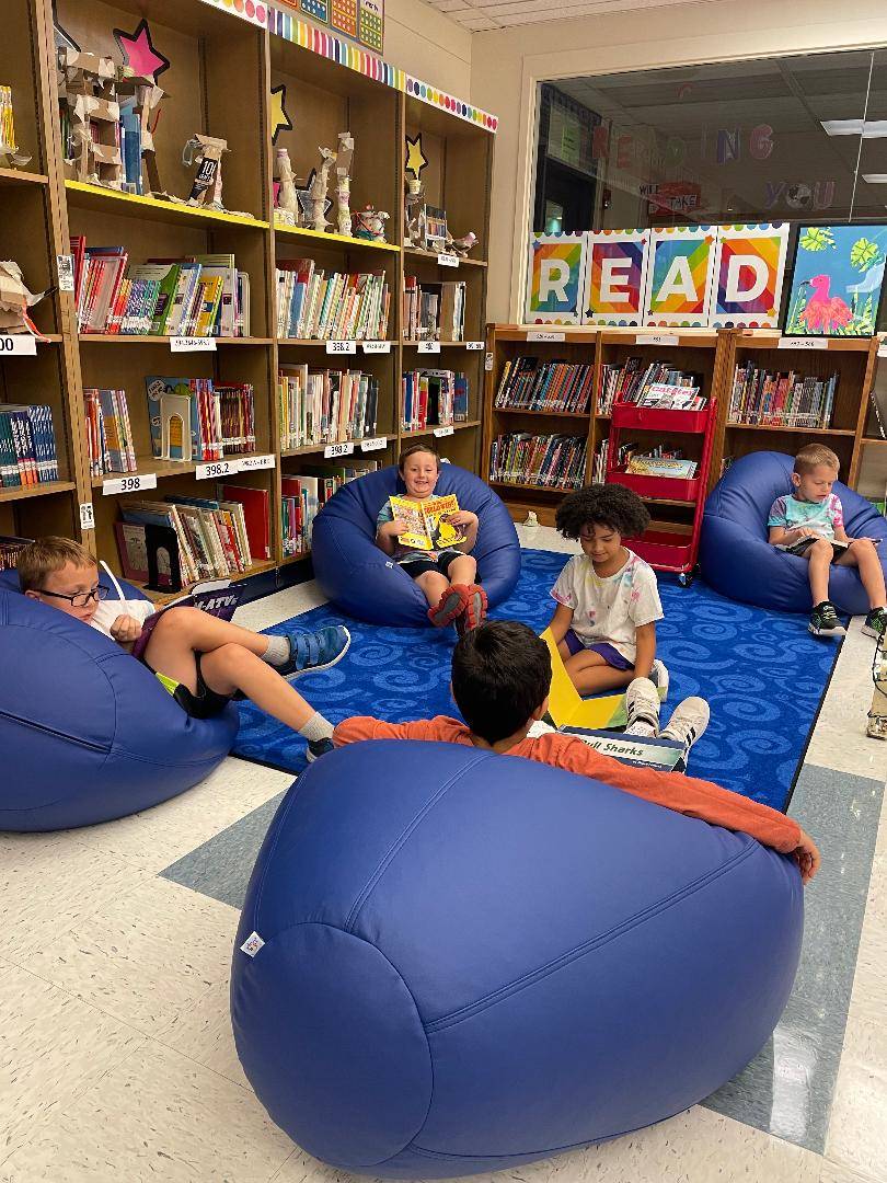 Marzolf Students sit in bean bags in the library