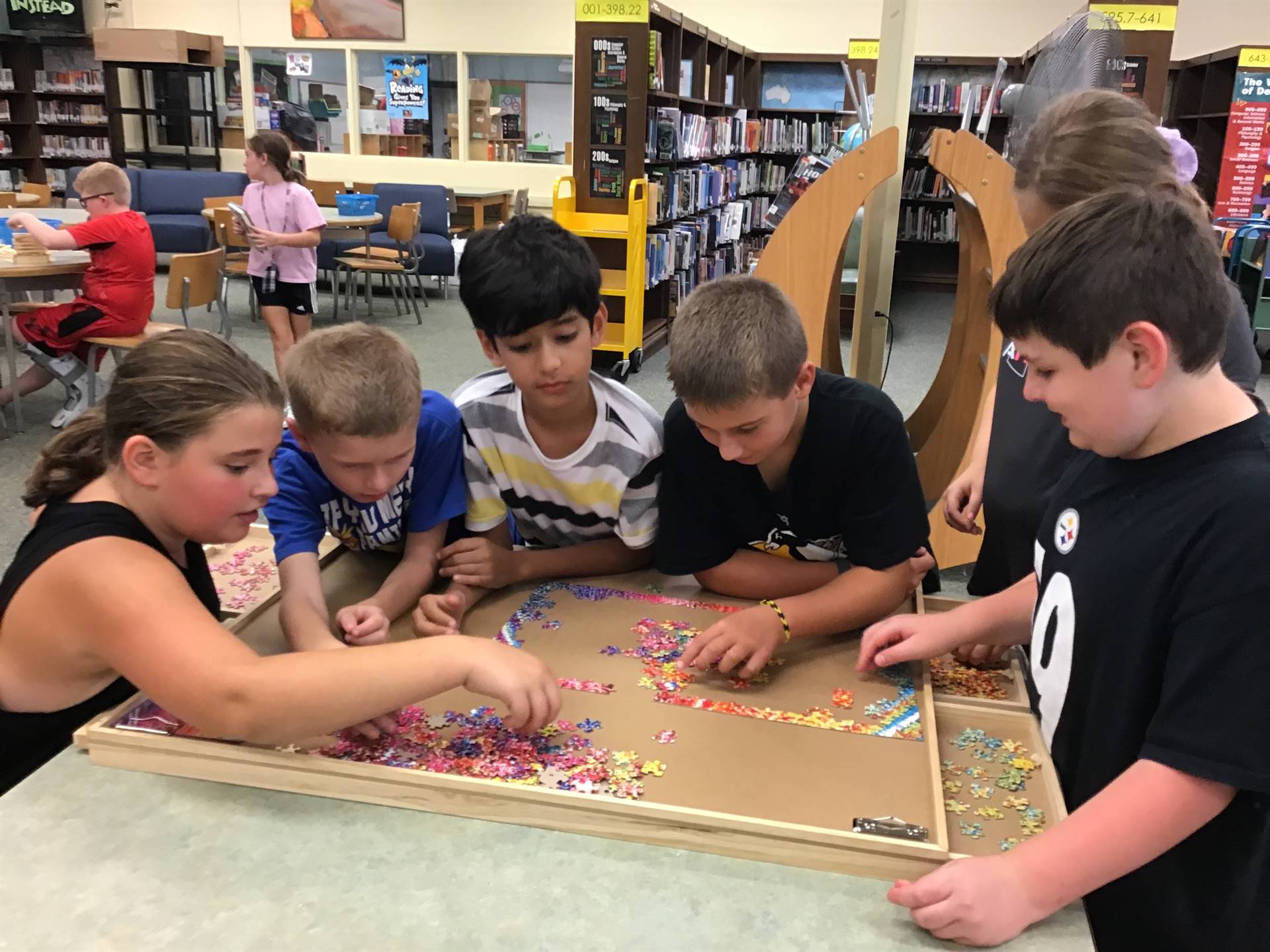 5th graders working on a puzzle 