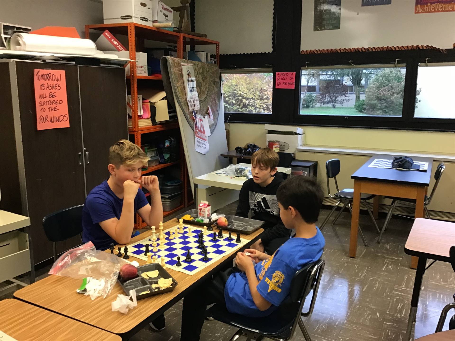 3 boys playing chess
