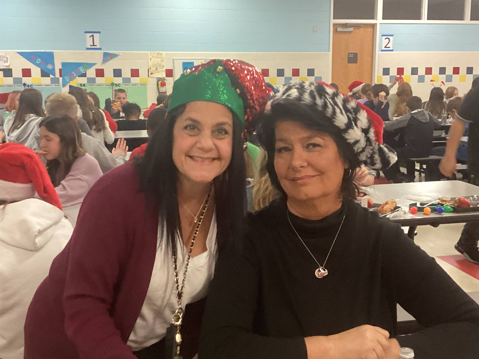 Two SAES staff members in holiday hats