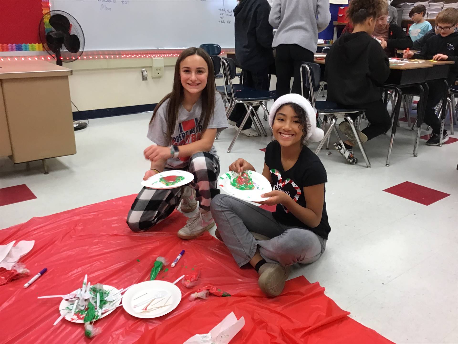 2 students with holiday cookie